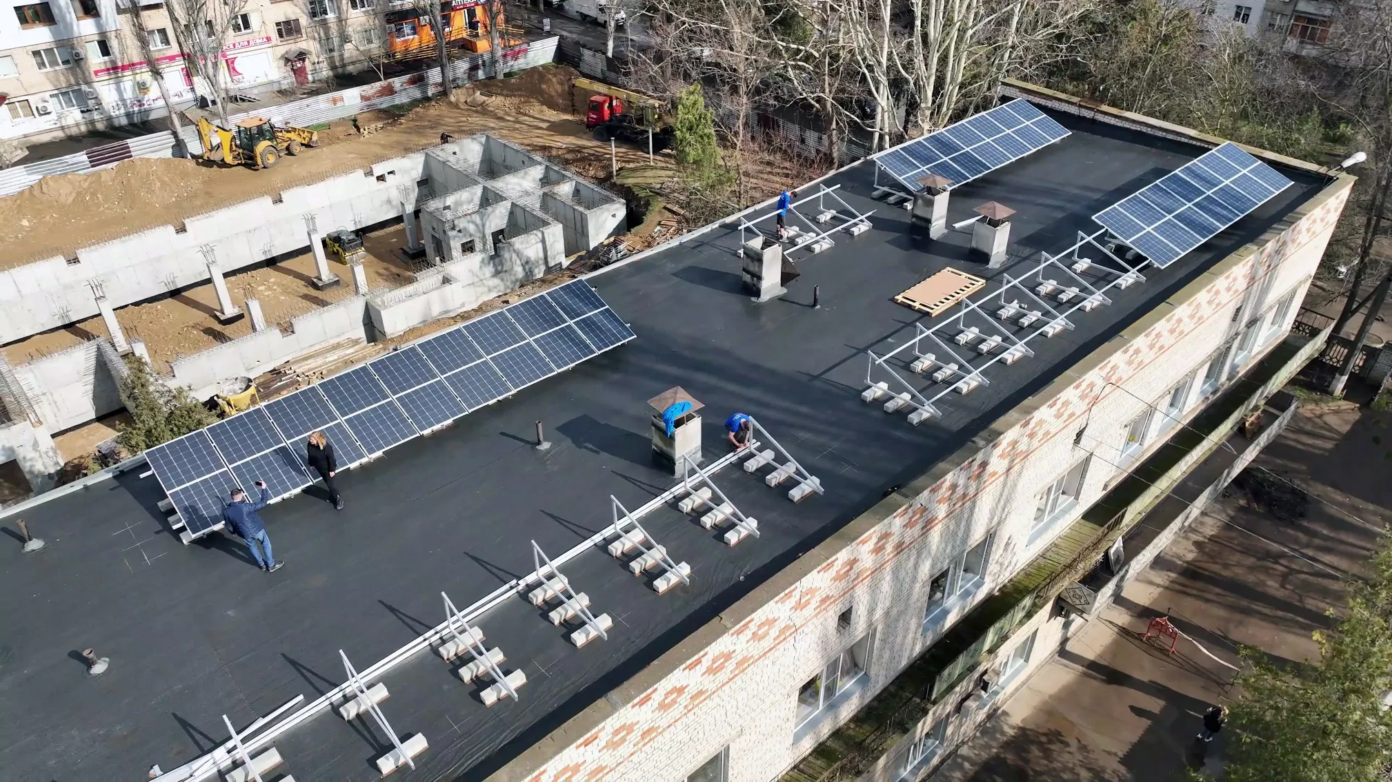 Installing solar panels on a rooftop in Ukraine